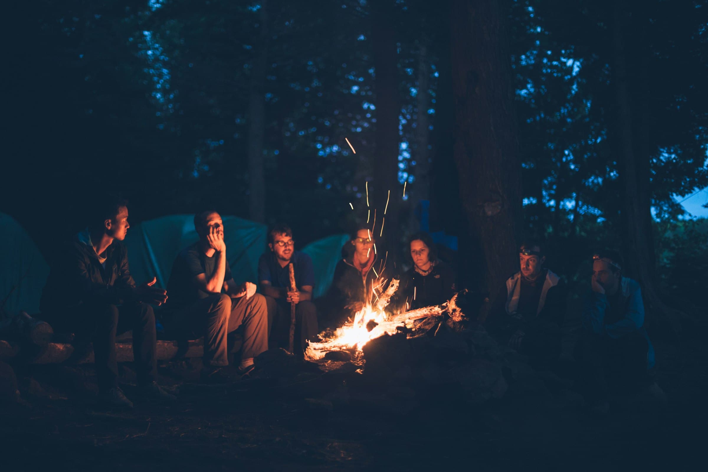 Men gathered around a fire at night